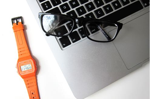 Image of laptop and orange glasses